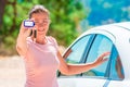 Girl shows rental car Keychain Royalty Free Stock Photo