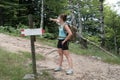 Girl shows the right direction during a mountain hike Royalty Free Stock Photo