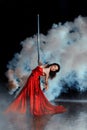 Girl shrouded in smoke dancing around a pole dance. Royalty Free Stock Photo