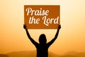 Girl with a sign with word praise the lord Royalty Free Stock Photo