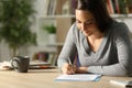 Girl signing document at home in the night Royalty Free Stock Photo