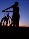 Girl silhouette of the cyclist riding