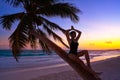 Girl silhouette palm tree Caribbean sunset Royalty Free Stock Photo