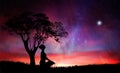 Girl silhouette under a tree, meditation in nature, under stars Royalty Free Stock Photo