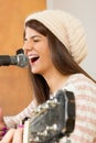 Girl singing loud and playing guitar Royalty Free Stock Photo