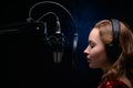Girl singing in a studio microphone in a recording studio Royalty Free Stock Photo