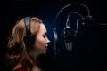 Girl singing in a studio microphone in a recording studio Royalty Free Stock Photo