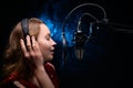 Girl sings.Microphone in a recording studio.Effective background.Vocal.Vocal schools and training