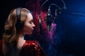 Girl sings into a microphone. Screensaver for a vocal school, work and training in vocals. Singing and lesson in music. Bright Royalty Free Stock Photo