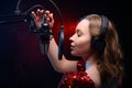 Girl sings into a microphone. Screensaver for a vocal school, work and training in vocals. Singing and lesson in music. Bright