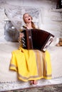 The girl sings and plays the accordion Royalty Free Stock Photo