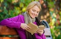 Girl sit bench relaxing with book fall nature background. Intellectual hobby. Lady bookworm read book outdoors fall day