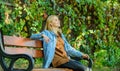 Girl sit bench relaxing fall nature background. Feeling free and relaxed. Woman blonde take break relaxing in park. You Royalty Free Stock Photo