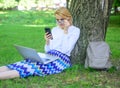 Girl sit grass with notebook. Sales manager occupation benefits. Woman with laptop in park order item on phone. Girl Royalty Free Stock Photo