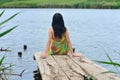 Girl sit on a pier Royalty Free Stock Photo