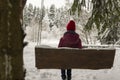 Girl sit on a swing in the winter forest Royalty Free Stock Photo