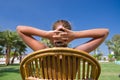 Girl sits in an armchair on a grass