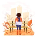 A girl sits on a bench in an autumn park and works at a laptop. Vector illustration in cartoon flat style