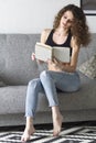 Girl sitting on the couch with a book. Royalty Free Stock Photo