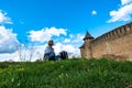 A girl sits on the grass near the ancient fortress, Khotyn Ukraine Royalty Free Stock Photo