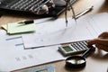 The girl sits at her desk and draws up graphs and histograms about income, business and finance, planning , economics