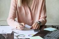 The girl sits at her desk and draws up graphs and histograms about income, business and finance, planning , economics