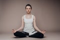 A girl sits in a lotus position and meditates with her eyes closed. Zen practice, breath technique. Consideration and praying