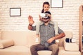 Girl Sits on Man`s Neck in Virtual Reality Glasses. Royalty Free Stock Photo