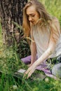 girl sits outdoors and works at a laptop. freelance. selfeducation. the concept of remote learning and outdoor work.