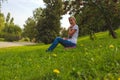 Girl sits in Park on the grass
