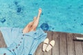 Girl sits on the pier near the parked boats on the Mediterranean coast. Vacation and travel concept Royalty Free Stock Photo