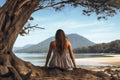 Girl sits in a quiet place on the shore of a lake