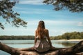 Girl sits in a quiet place on the shore of a lake