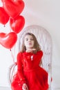 Beautiful girl sits with red heart balloons Royalty Free Stock Photo