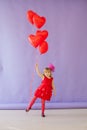 Beautiful girl sits with red heart balloons Royalty Free Stock Photo