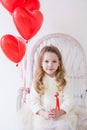 Little girl sits with red heart balloons Royalty Free Stock Photo