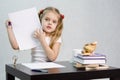 Girl shows sheet of paper with scribbled notes, sitting at the table in the image of the writer