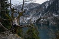 Girl sits on a tree and meditates near lake Ritsa in Abkhazia Royalty Free Stock Photo