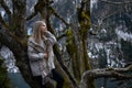 Girl sits on a tree and meditates near lake Ritsa in Abkhazia Royalty Free Stock Photo