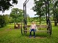 Girl sits on a very unusual old makeshift bench in the village