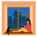 A girl sits by the window, reads a book