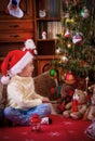 Girl sitting and admiring Christmas tree