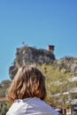 Girl is sitting alone and watching the castle