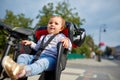 Girl sitting in a baby bike seat of a bicycle of her father safety emotions anxiety kids children parenting. Royalty Free Stock Photo