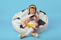 Girl sitting on bean bag chair, holding joystick and playing video game Royalty Free Stock Photo