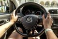 The girl sitting behind the wheel of a Volkswagen Polo car