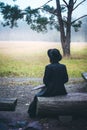 Girl sitting on a bench, view from the back Royalty Free Stock Photo