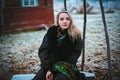 Girl sitting on a bench in the vill