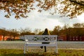 A girl sitting on benches under trees in Kastellet fortess