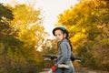 Girl sitting on the bike. walk in the autumn. riding on the road